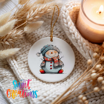 Snowman in Red Hat and Blue Scarf Christmas ornament styled beside a candle and cozy knit blanket