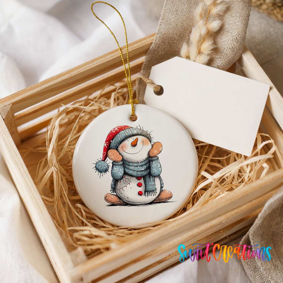 Snowman in Blue Hat and Scarf Christmas ornament presented in a rustic wooden gift crate