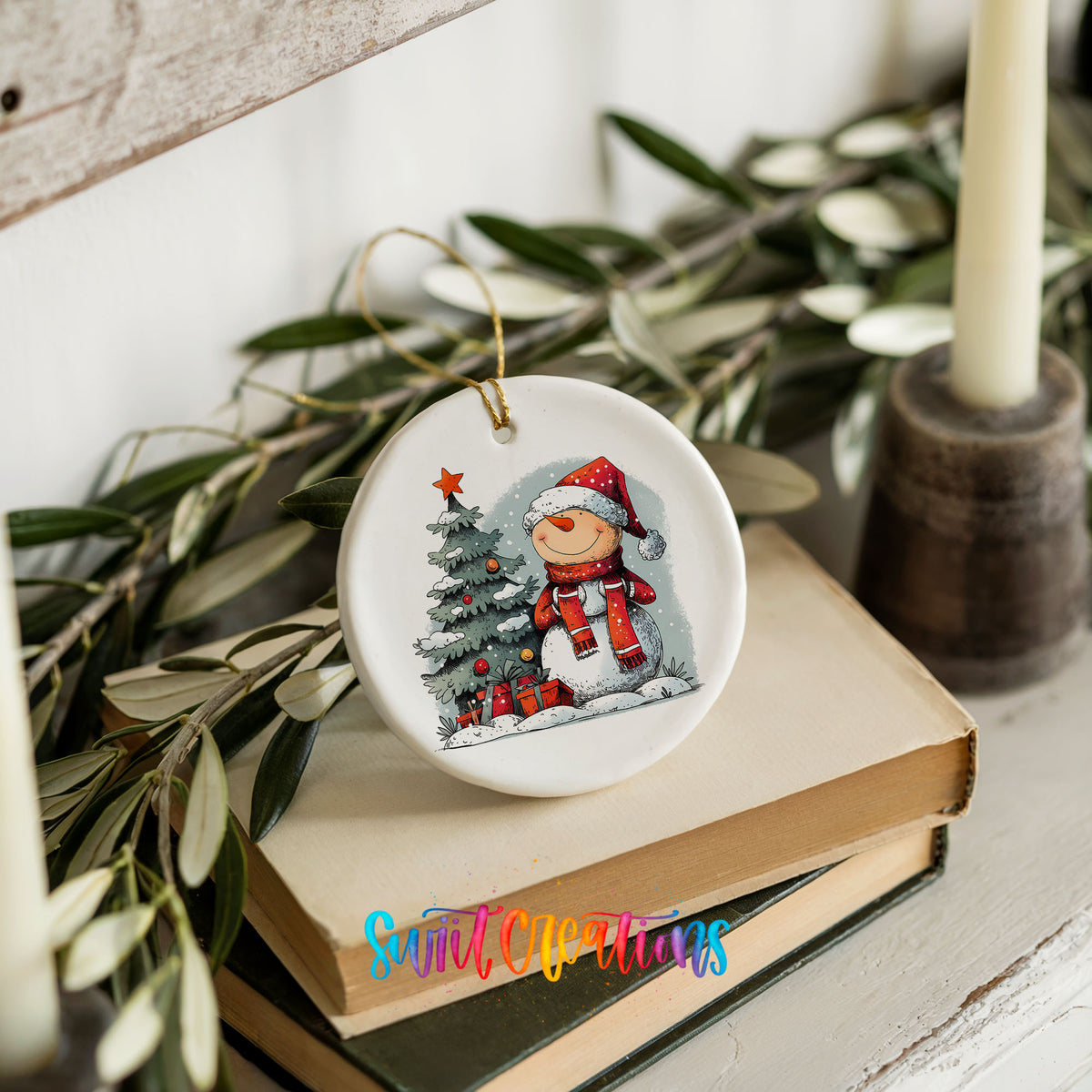 Santa Decorating a Christmas Tree Christmas ornament styled on books with holiday greenery