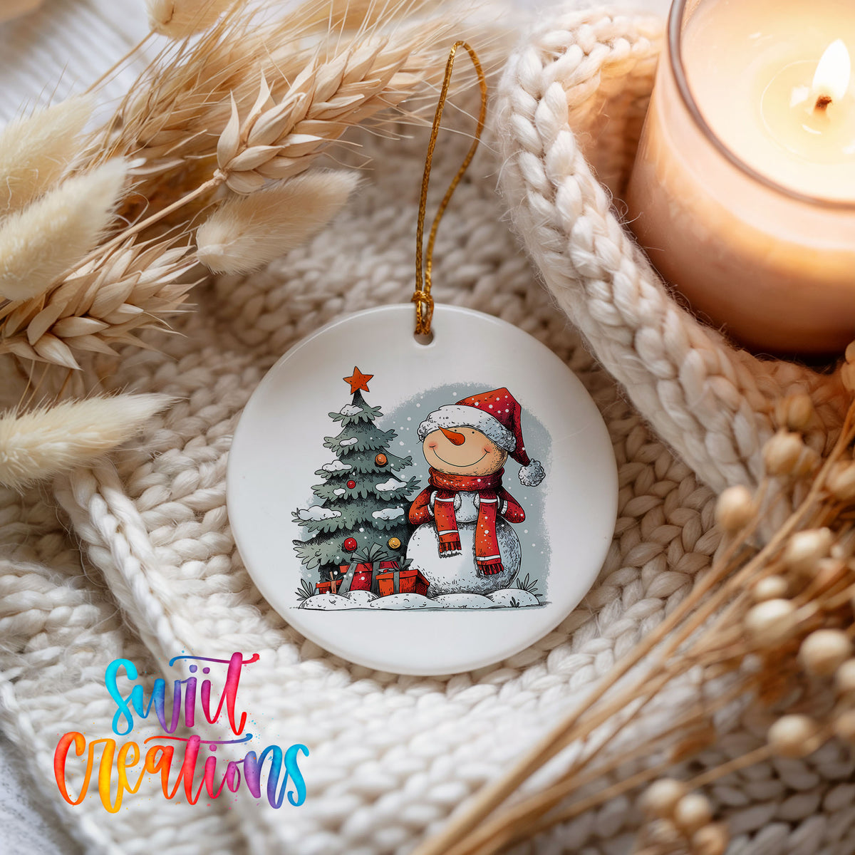 Santa Decorating a Christmas Tree Christmas ornament styled beside a candle and cozy knit blanket