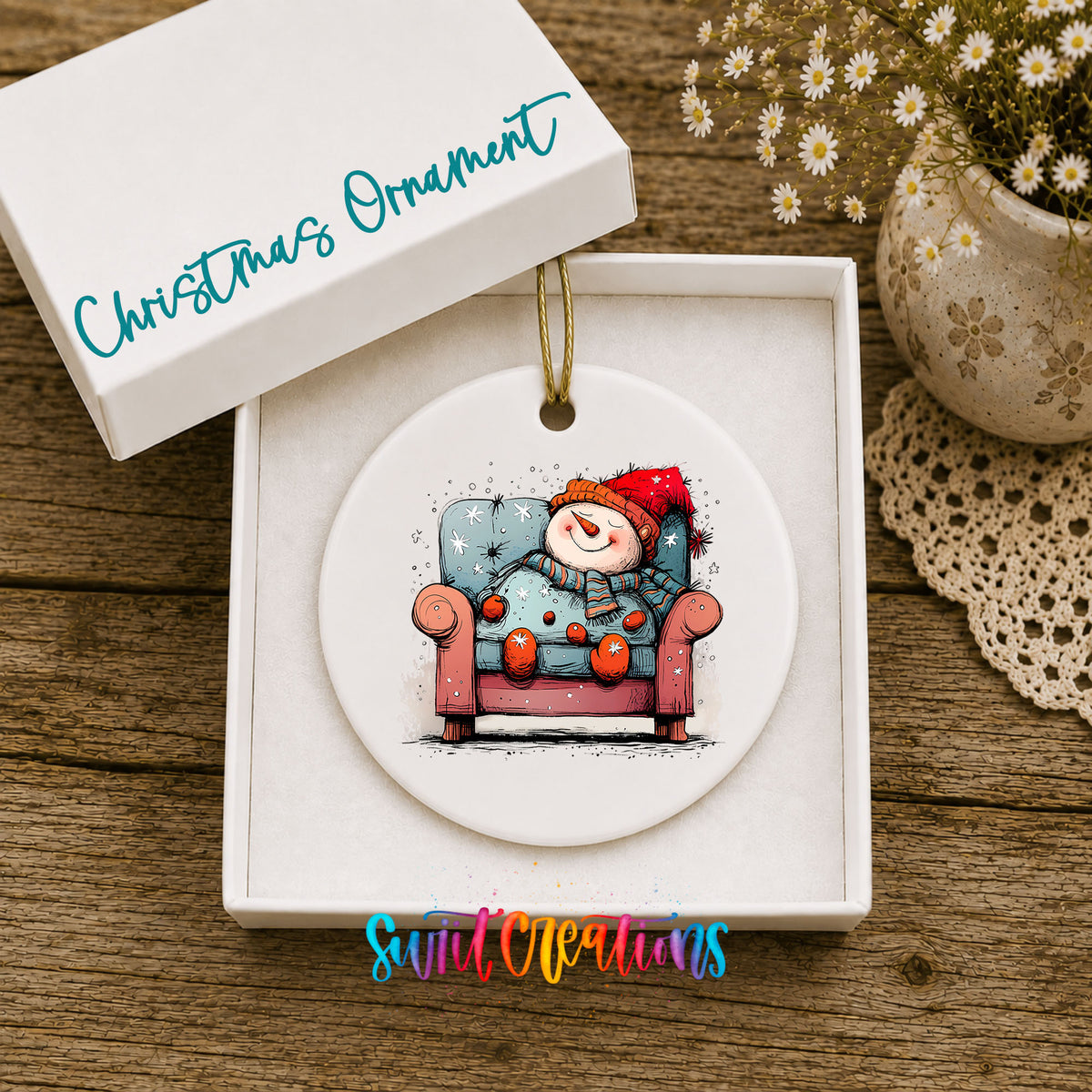 Santa Resting in a Holiday Armchair Christmas ornament displayed in an included gift box