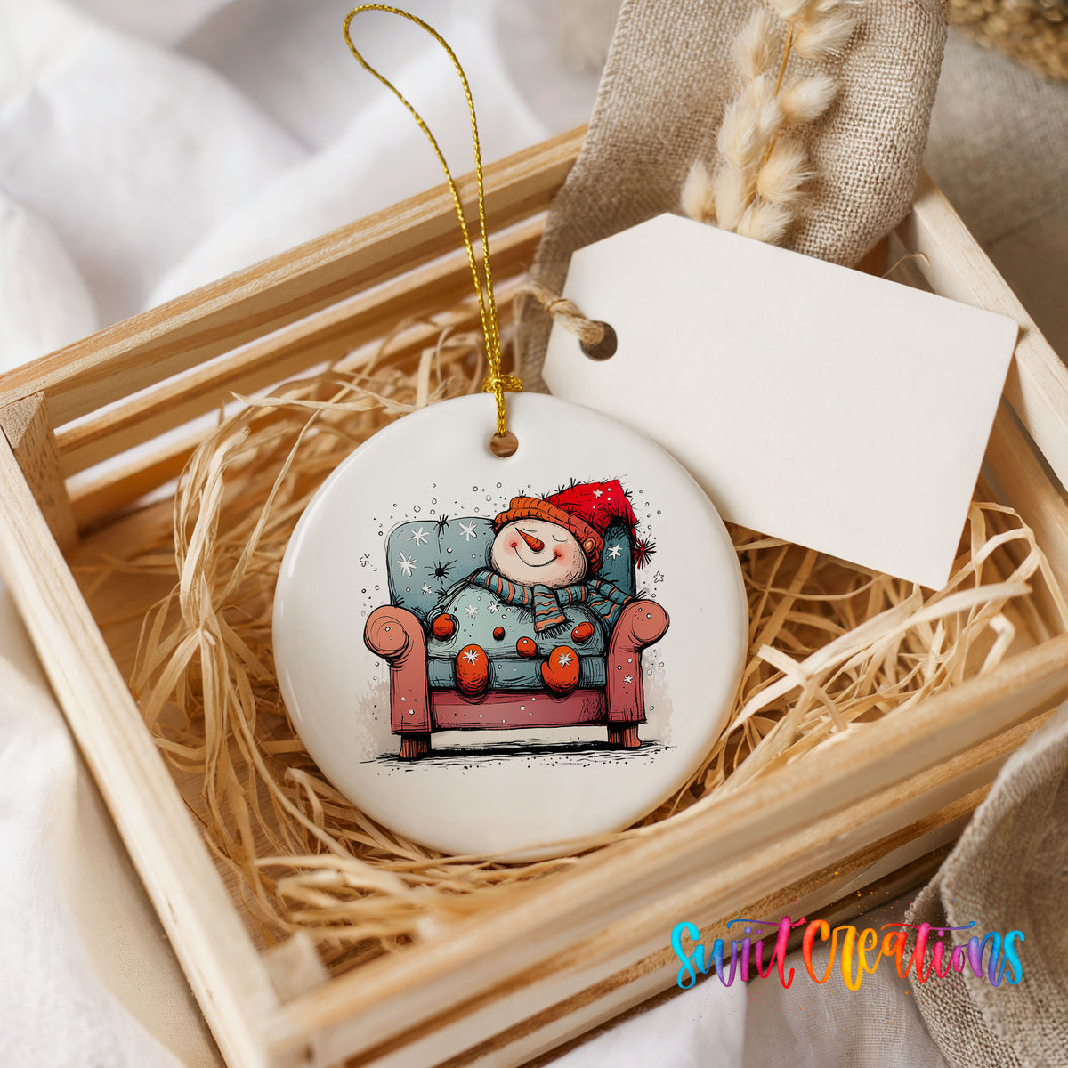 Santa Resting in a Holiday Armchair Christmas ornament presented in a rustic wooden gift crate