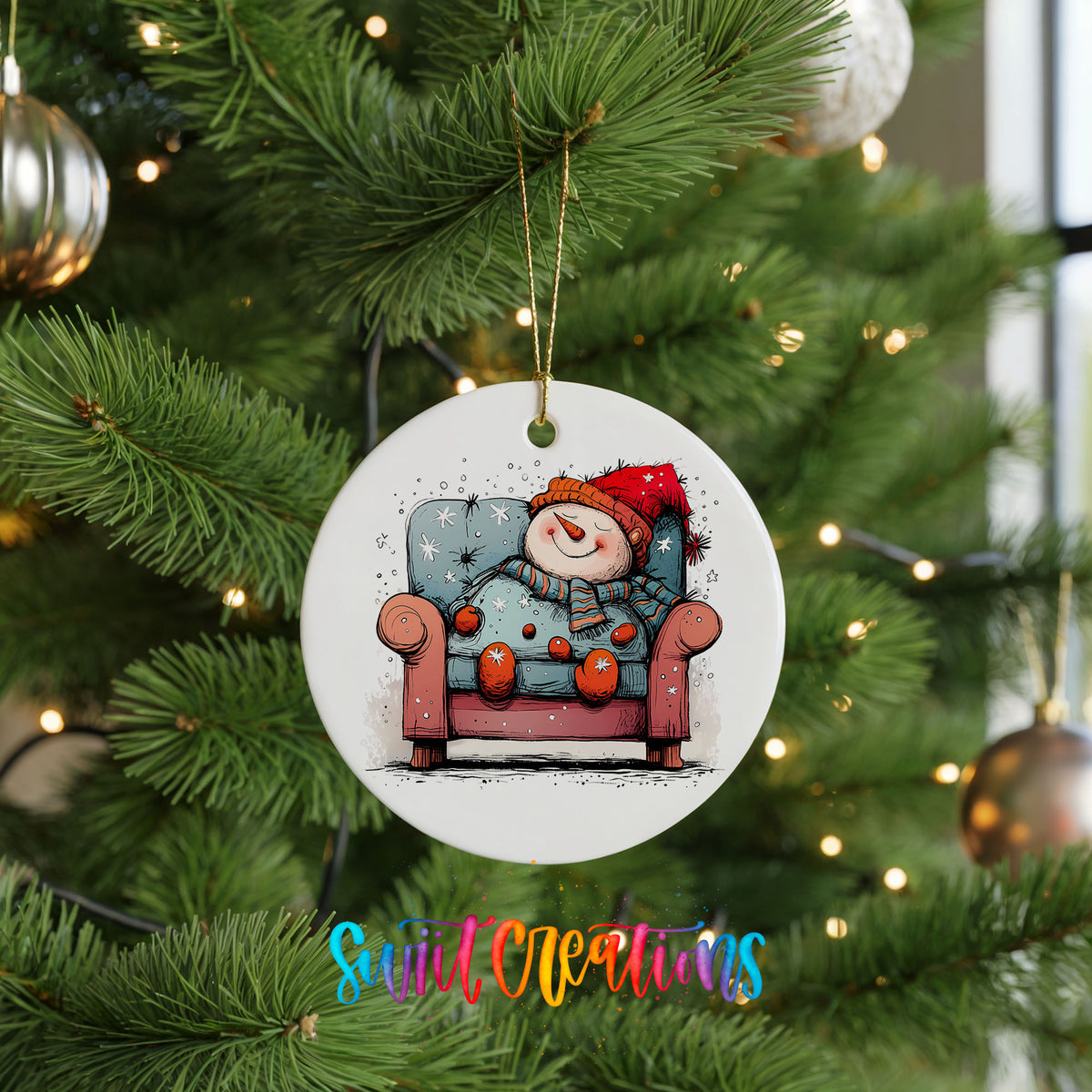 Santa Resting in a Holiday Armchair Christmas ornament hanging on a green Christmas tree