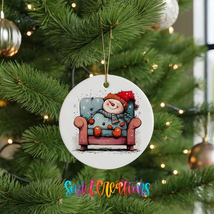 Santa Resting in a Holiday Armchair Christmas ornament hanging on a green Christmas tree