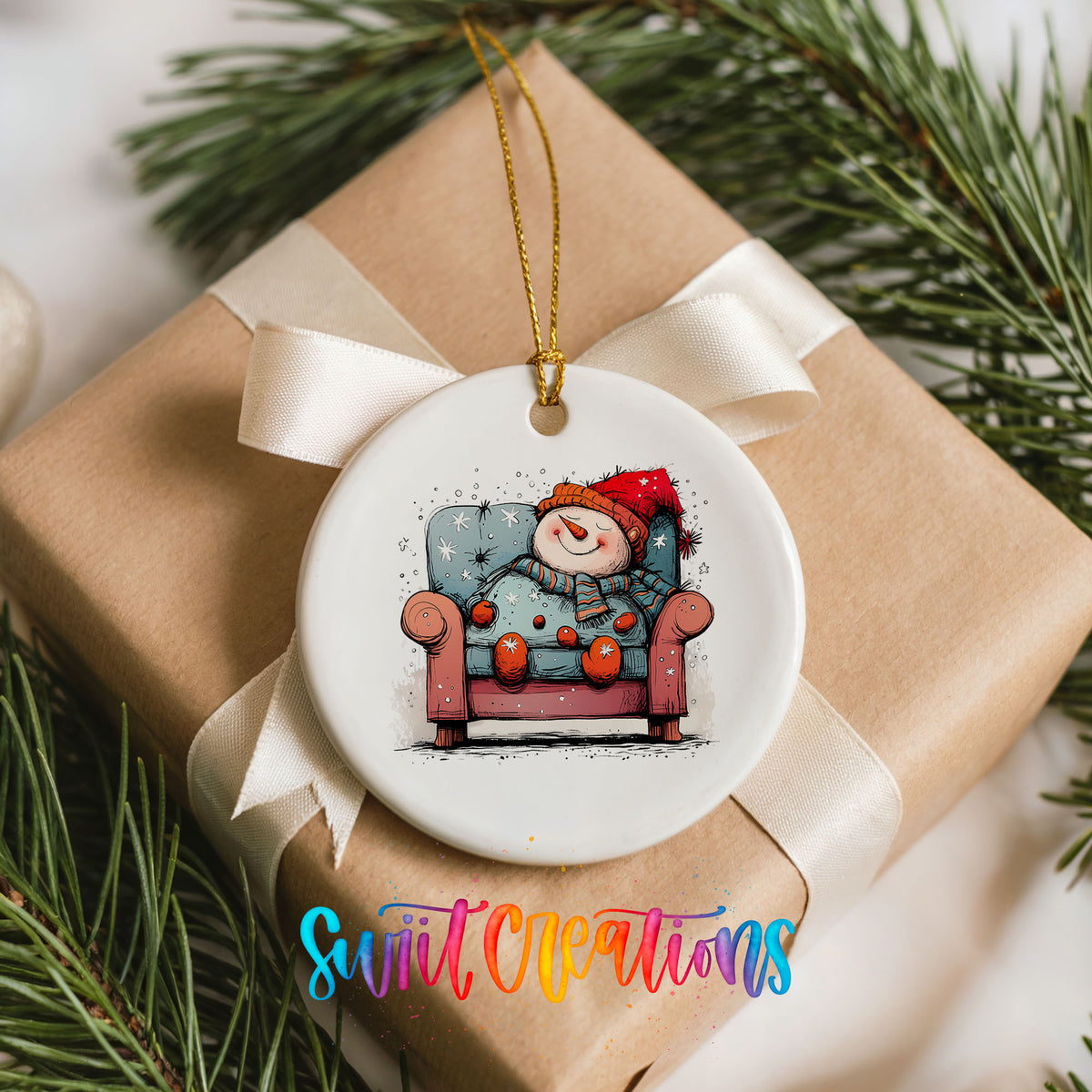 Santa Resting in a Holiday Armchair Christmas ornament placed on a wrapped Christmas gift