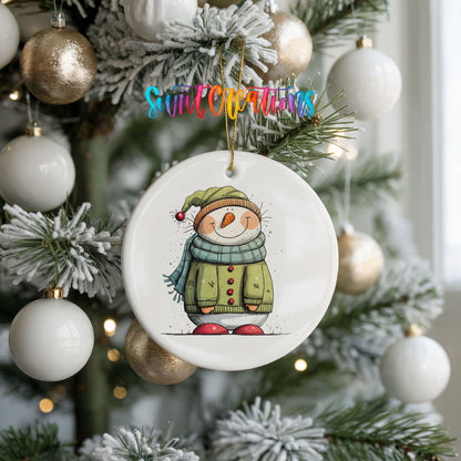 Snowman in Green Winter Coat Christmas ornament hanging on a frosted holiday tree
