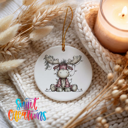 pink reindeer wrapped in Christmas lights ceramic Christmas ornament styled on a cozy knit blanket