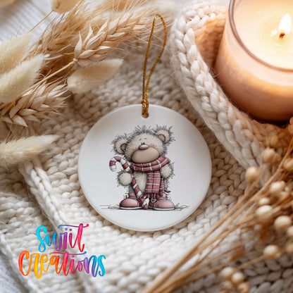 teddy bear holding a candy cane in winter clothes ceramic Christmas ornament styled on a cozy knit blanket
