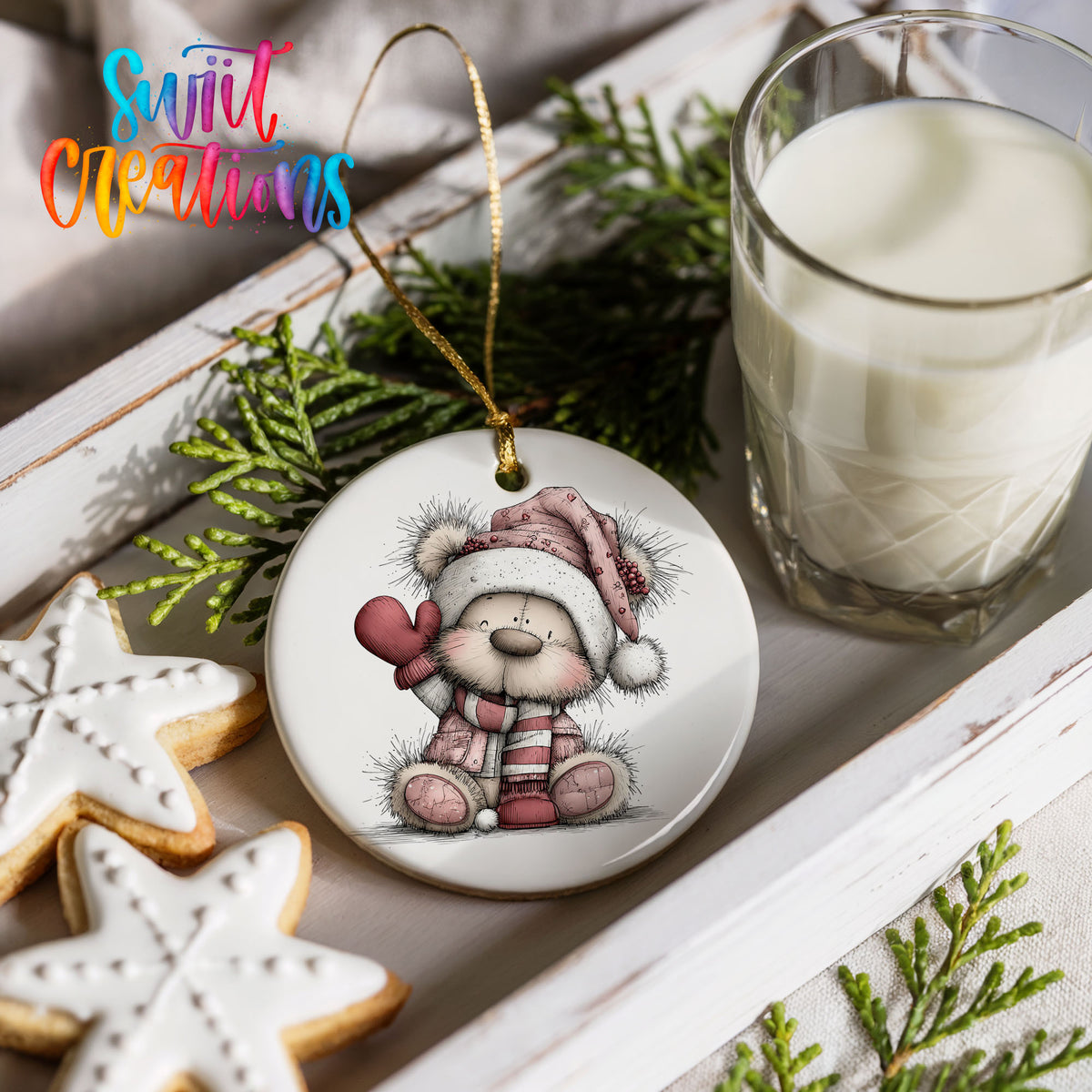 teddy bear holding a pink heart in a Santa hat ceramic Christmas ornament styled with holiday cookies and a candle