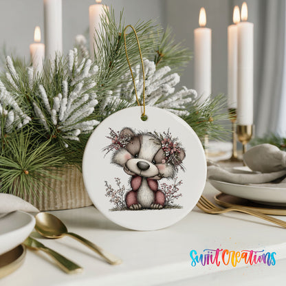 raccoon with winter flowers and greenery ceramic Christmas ornament shown in a holiday table setting