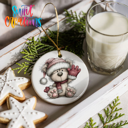 teddy bear waving beside Christmas gifts ceramic Christmas ornament styled with holiday cookies and a candle