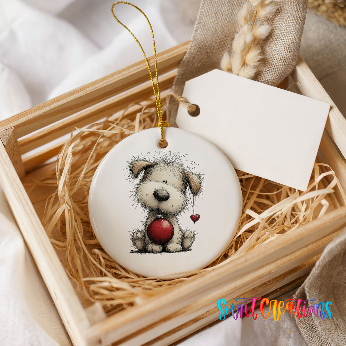 fluffy Christmas puppy holding a red ornament ceramic Christmas ornament displayed in a wooden gift crate