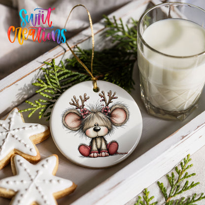 Christmas mouse wearing reindeer antlers and a red scarf ceramic Christmas ornament styled with holiday cookies and a candle