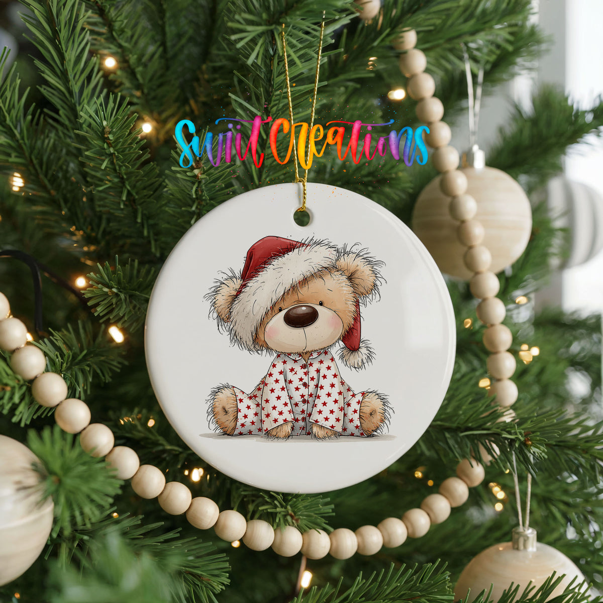 teddy bear in a Santa hat and pink polka dot scarf ceramic Christmas ornament hanging on a green Christmas tree