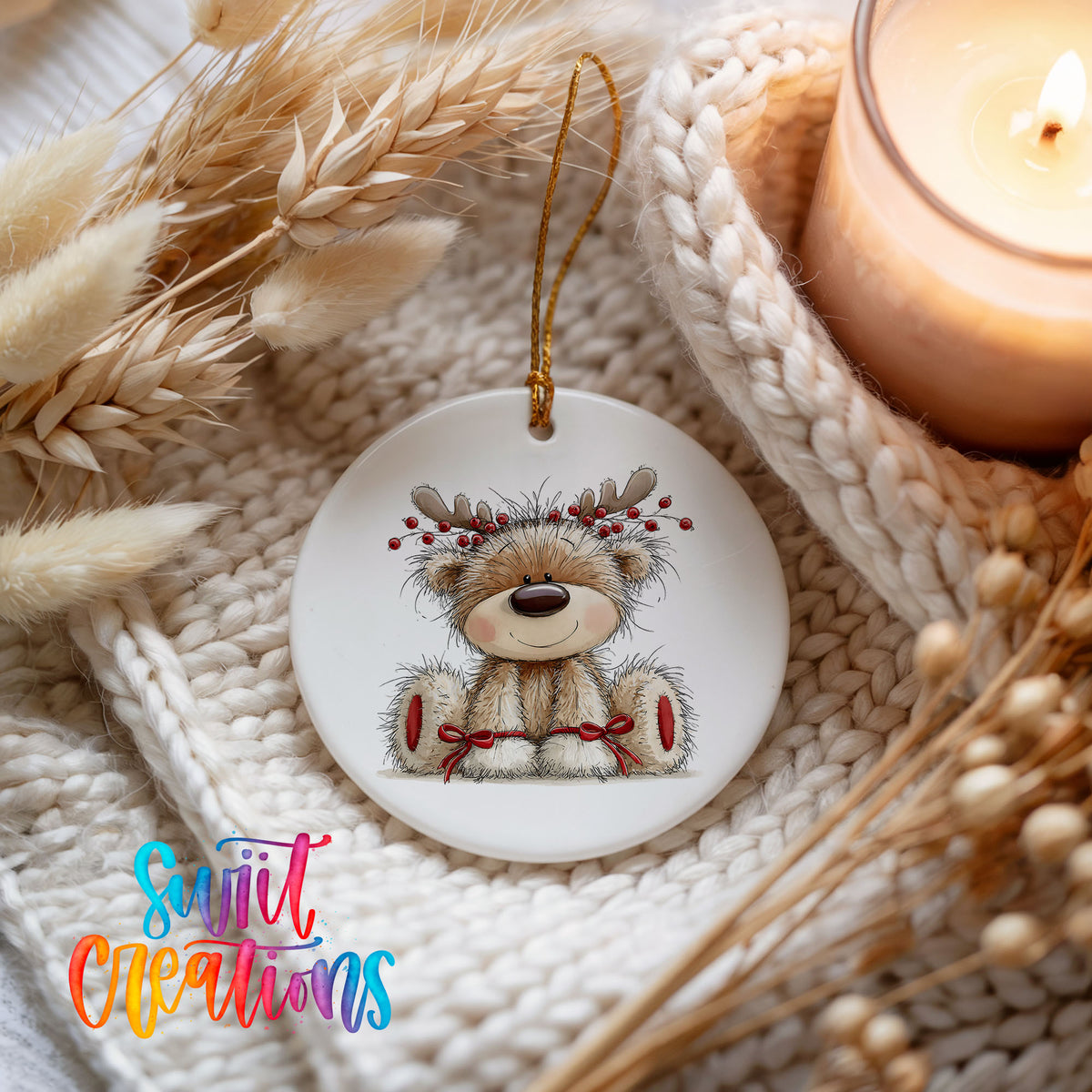 teddy bear wearing reindeer antlers with red winter skis ceramic Christmas ornament styled on a cozy knit blanket