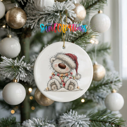 polar bear in a Santa hat and striped scarf ceramic Christmas ornament hanging on a frosted tree with ornaments