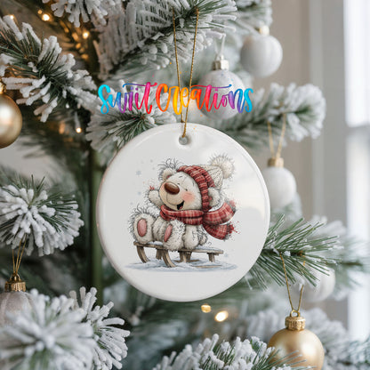polar bear in a red winter scarf playing in the snow ceramic Christmas ornament hanging on a frosted Christmas tree
