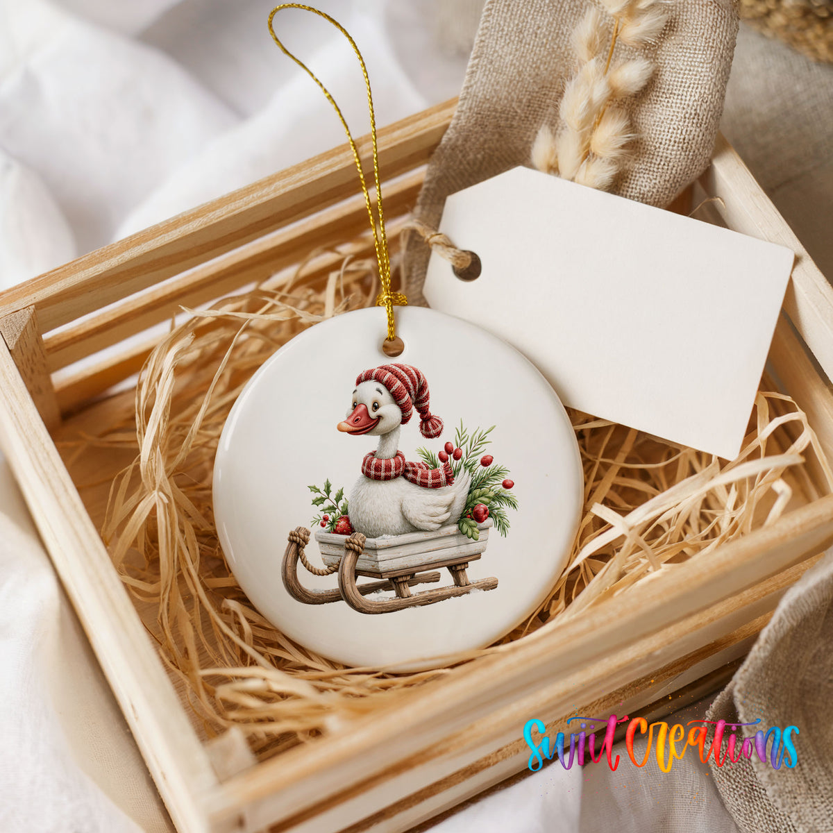 Christmas goose riding on a wooden sled ceramic Christmas ornament displayed in a wooden gift crate