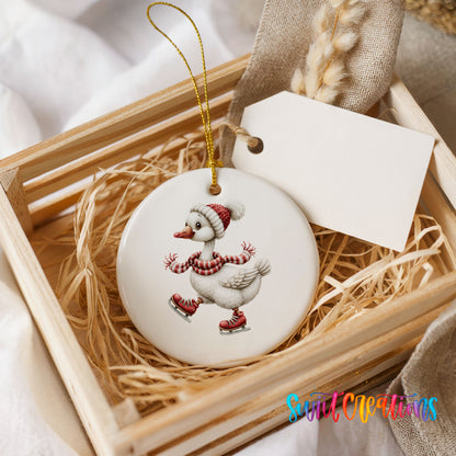 ice skating Christmas goose in a striped scarf ceramic Christmas ornament displayed in a wooden gift crate