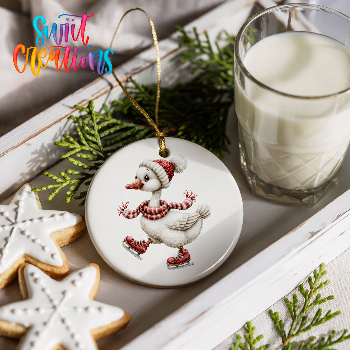 ice skating Christmas goose in a striped scarf ceramic Christmas ornament styled with holiday cookies and a candle