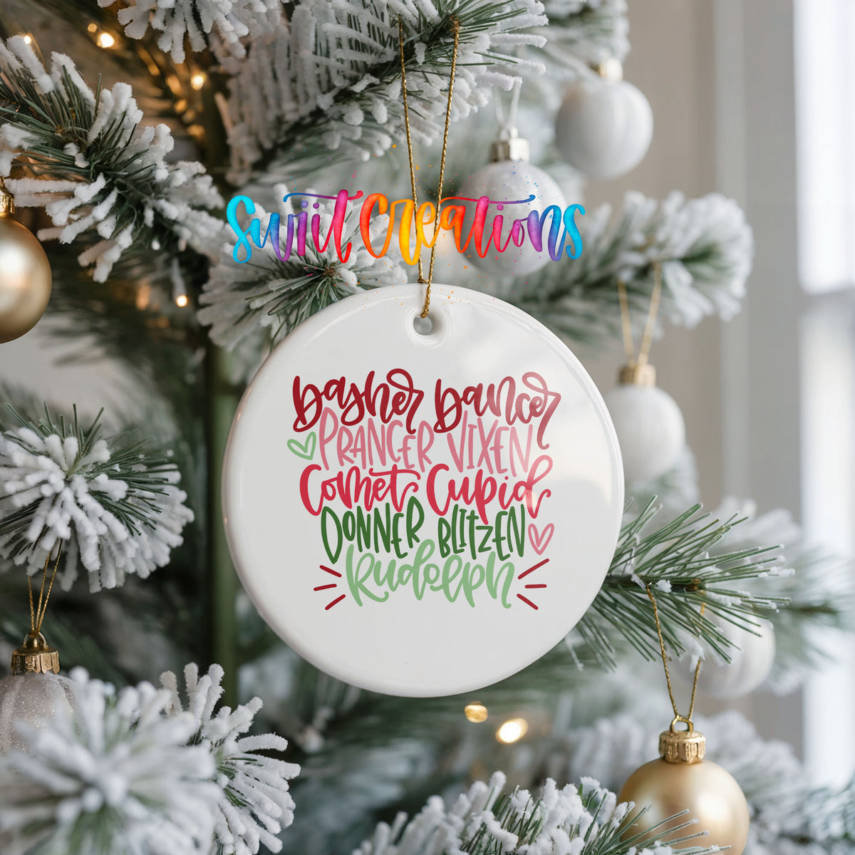Colorful reindeer names typography ceramic Christmas ornament hanging on a frosted Christmas tree