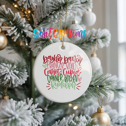 Colorful reindeer names typography ceramic Christmas ornament hanging on a frosted Christmas tree