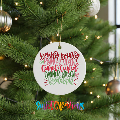 Colorful reindeer names typography ceramic Christmas ornament hanging on a green Christmas tree