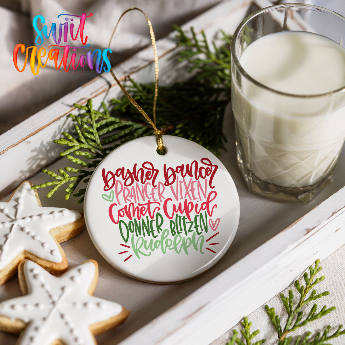 Colorful reindeer names typography ceramic Christmas ornament styled with cookies and milk
