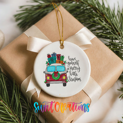 Have Yourself a Merry Little Christmas vintage truck ceramic Christmas ornament arranged on a wrapped Christmas gift