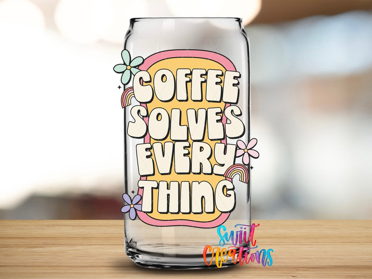 Coffee Solves Everything UV DTF transfer applied to a clear glass can from Swiit Creations