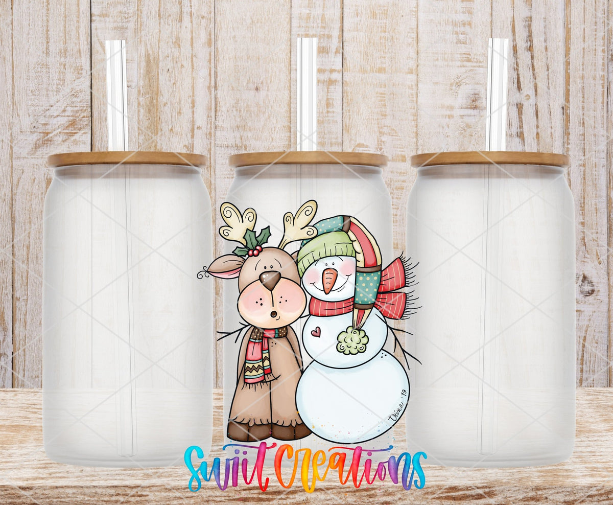 Three clear glass cans with the Reindeer and Snowman Christmas UV DTF transfer by Swiit Creations