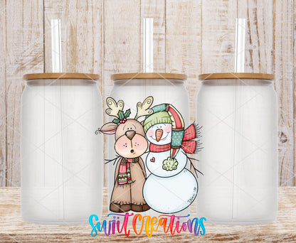 Three clear glass cans with the Reindeer and Snowman Christmas UV DTF transfer by Swiit Creations