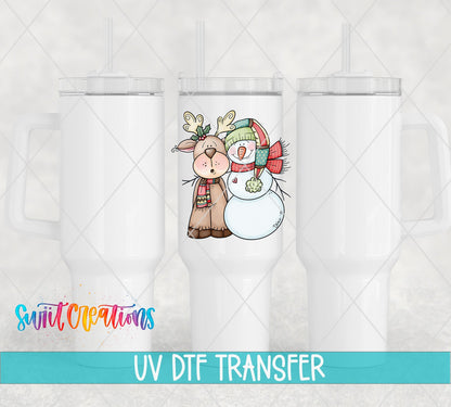 Three white tumblers featuring the Reindeer and Snowman UV DTF transfer by Swiit Creations