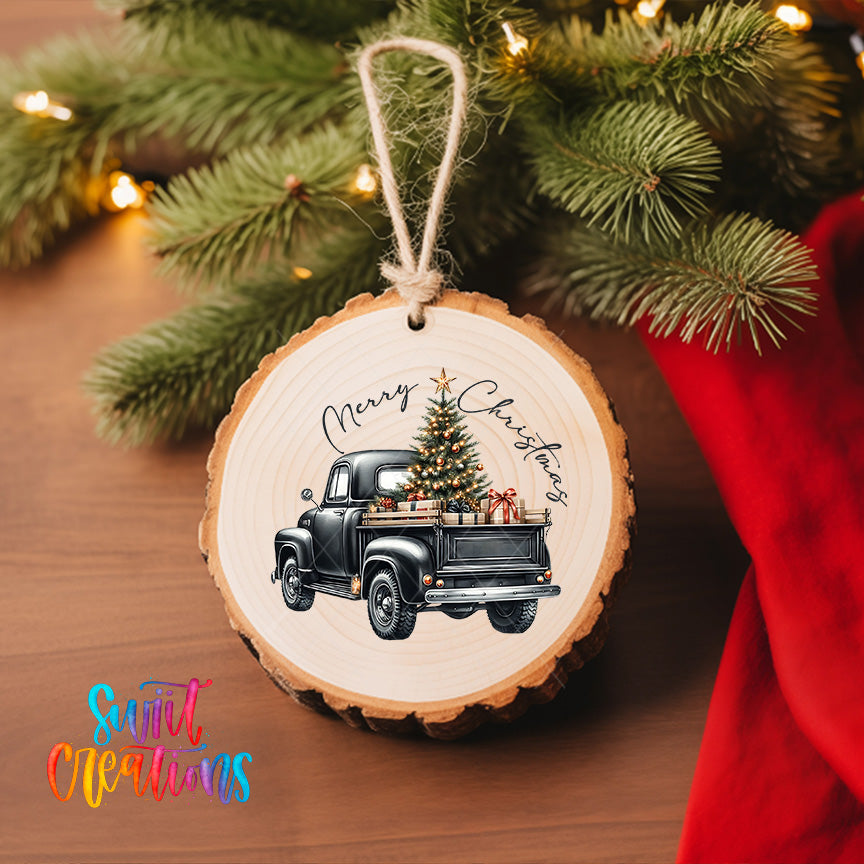 A wooden ornament hanging on a Christmas tree, featuring a vintage truck with a decorated Christmas tree in its bed.