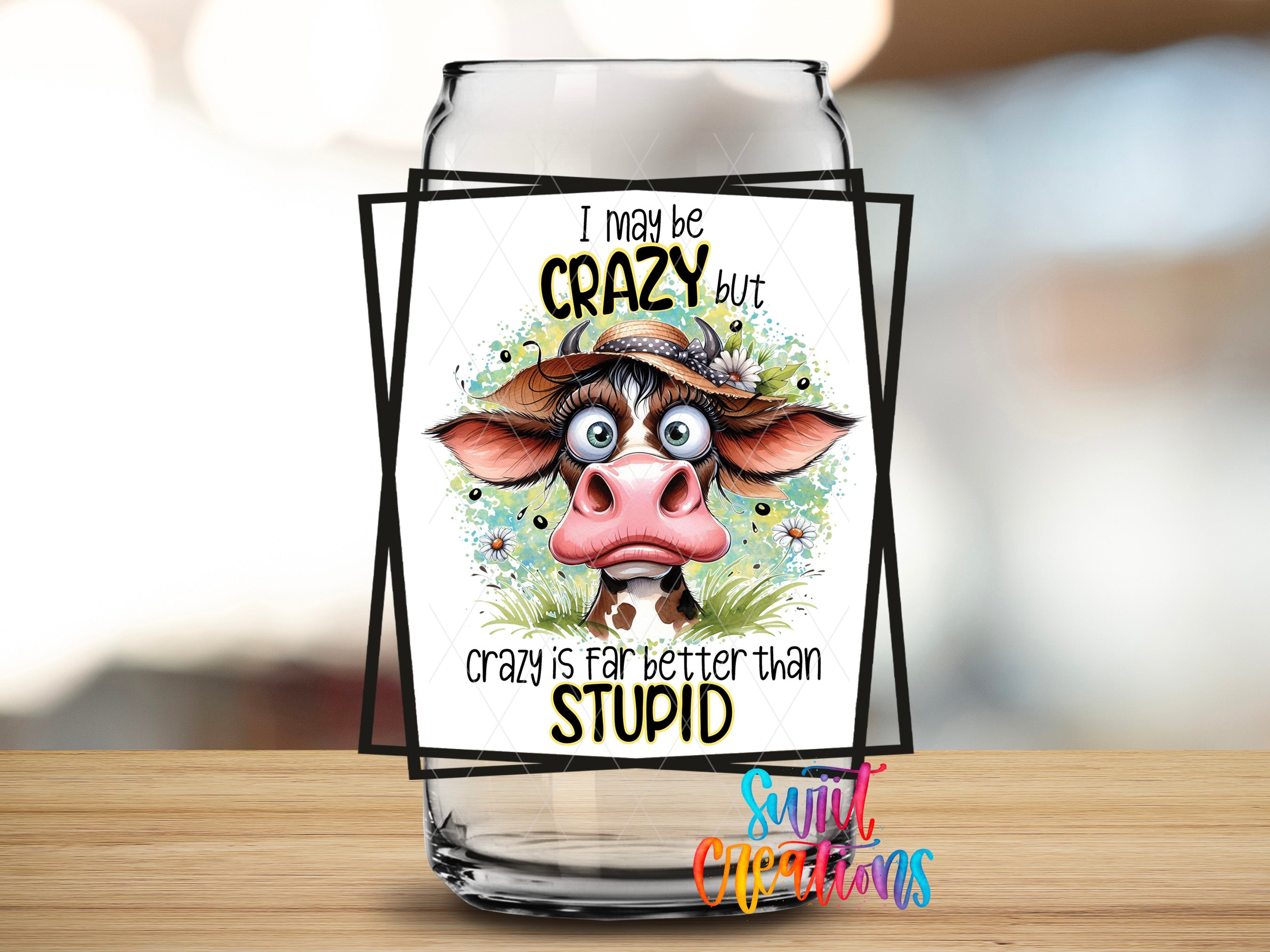 a glass jar with a cartoon cow on it, along with a humorous text overlay that reads "I may be crazy but crazy is far better than stupid".