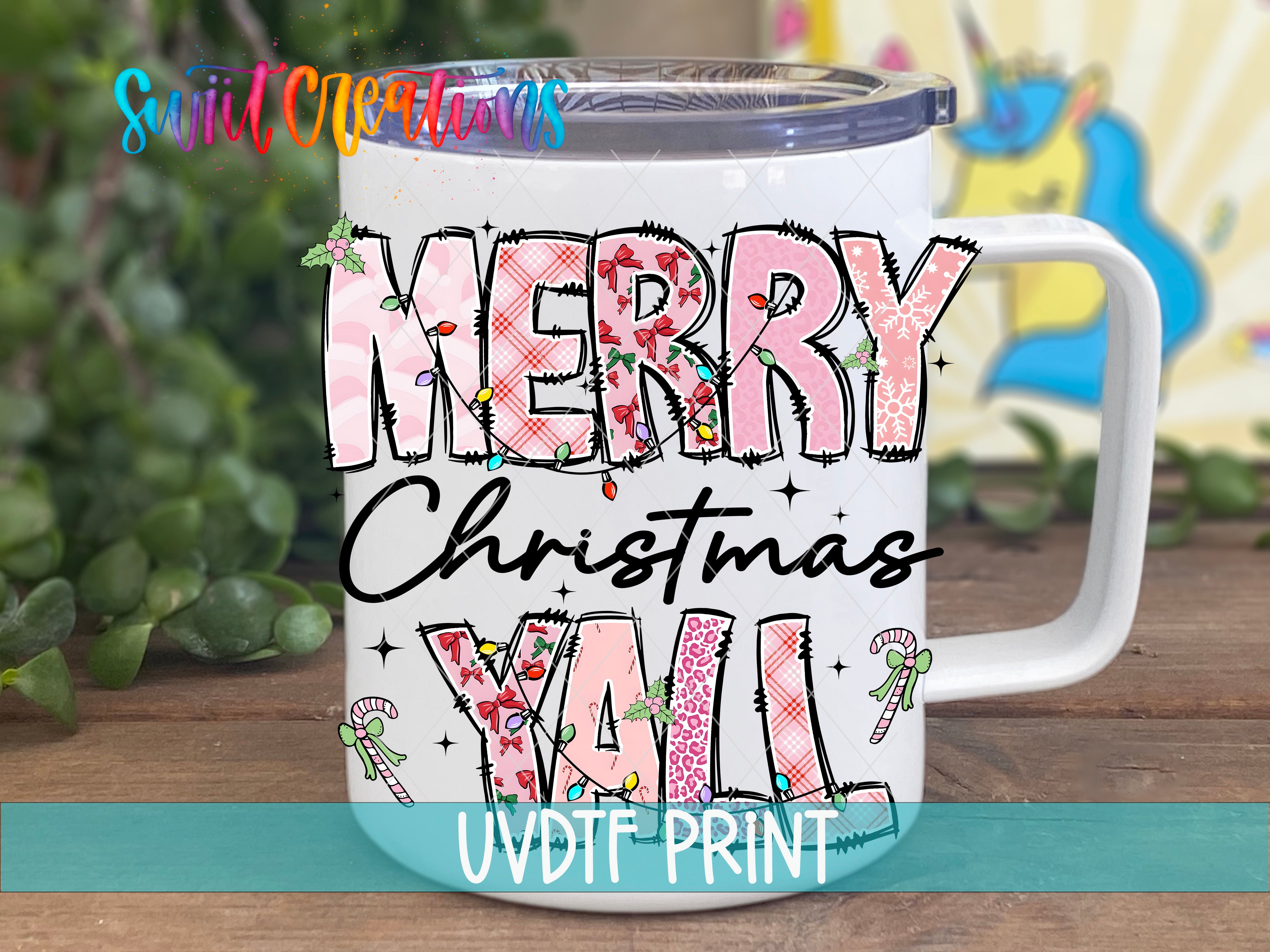 A white mug with a colorful design featuring the text "MERRY CHRISTMAS YALL" and various Christmas-themed elements such as snowflakes, pine cones, and candy canes.