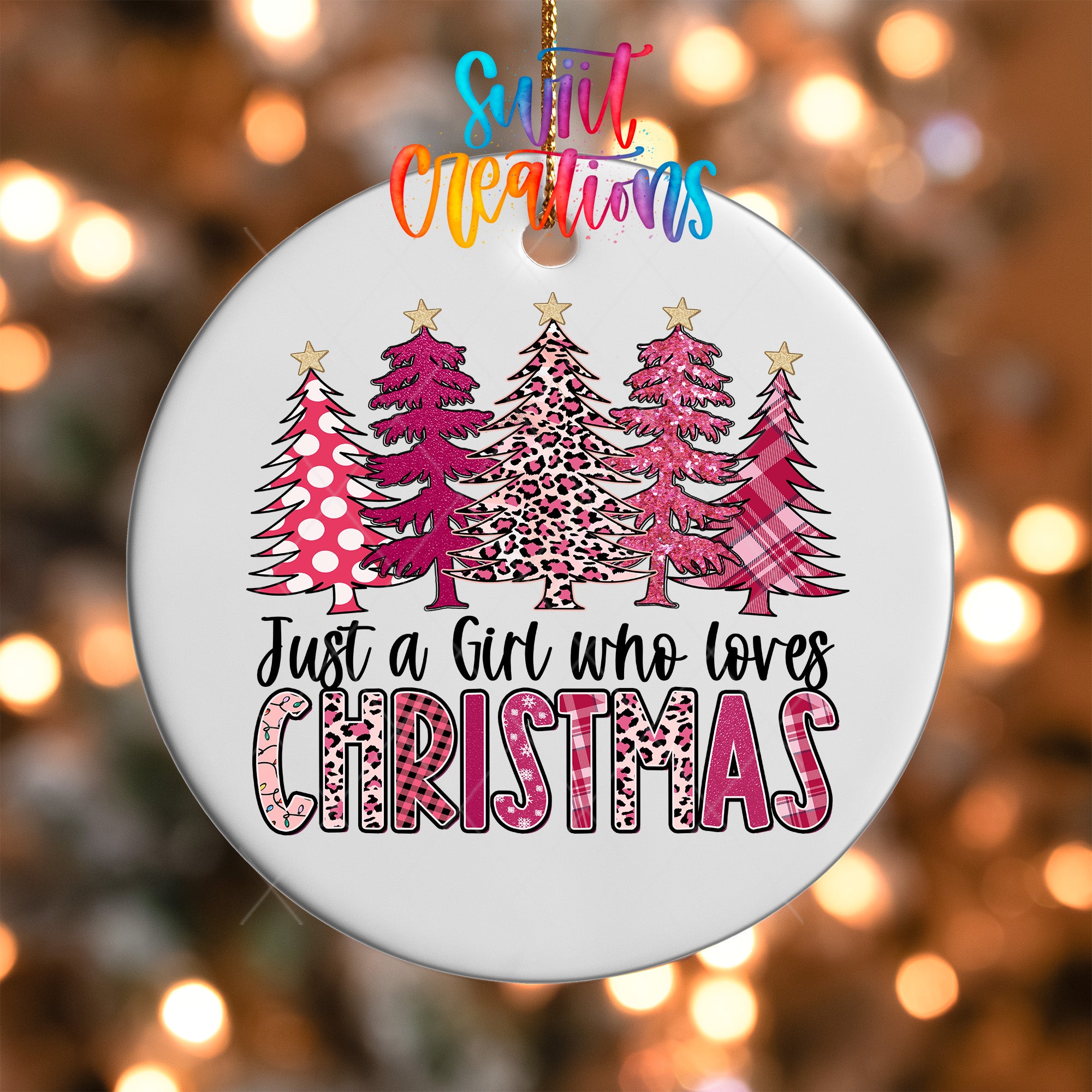 A white Christmas ornament with a design of pink and leopard print trees, along with the text "Just a Girl who loves Christmas".