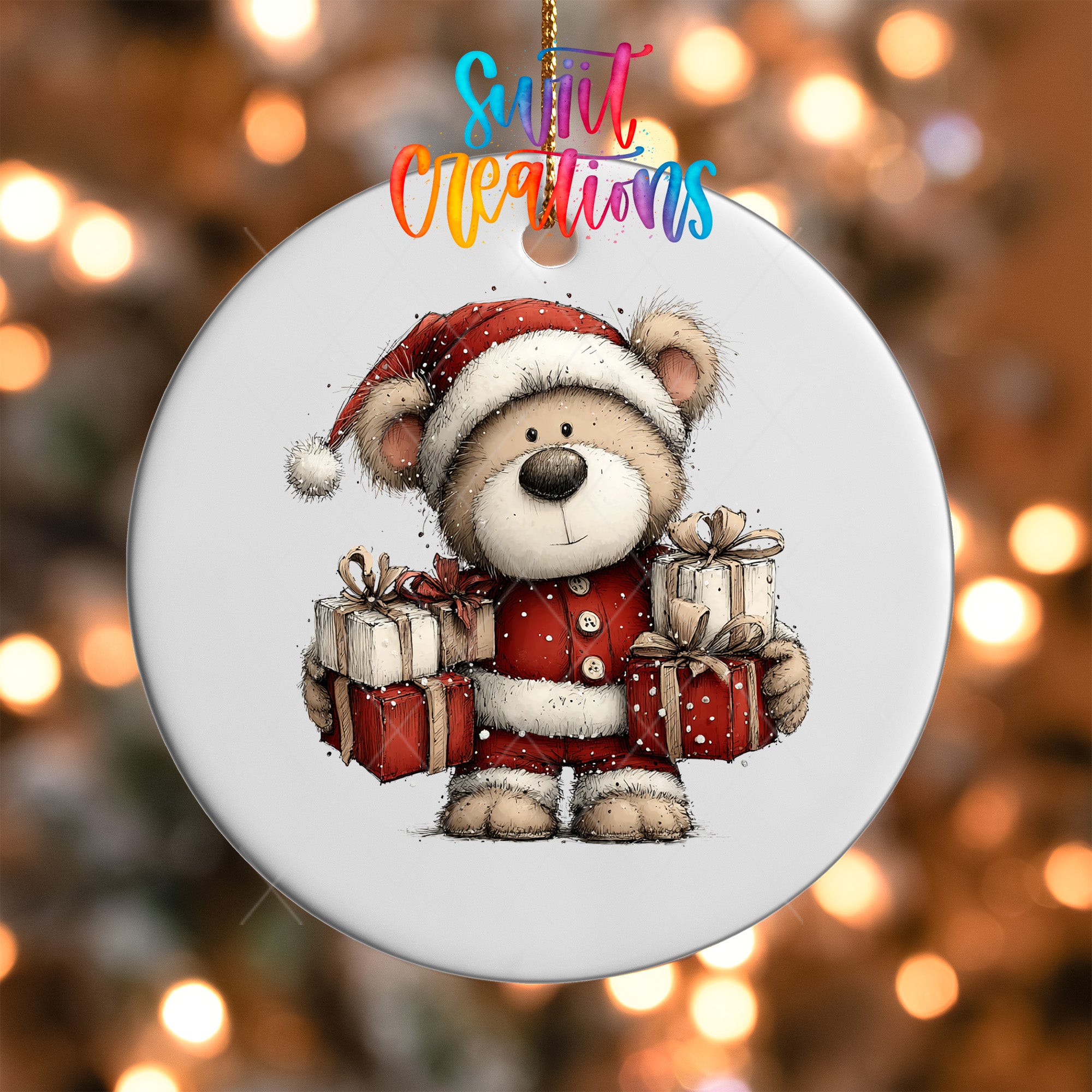 A white ornament with a teddy bear wearing a Santa hat and holding presents, set against a blurred background with Christmas lights.