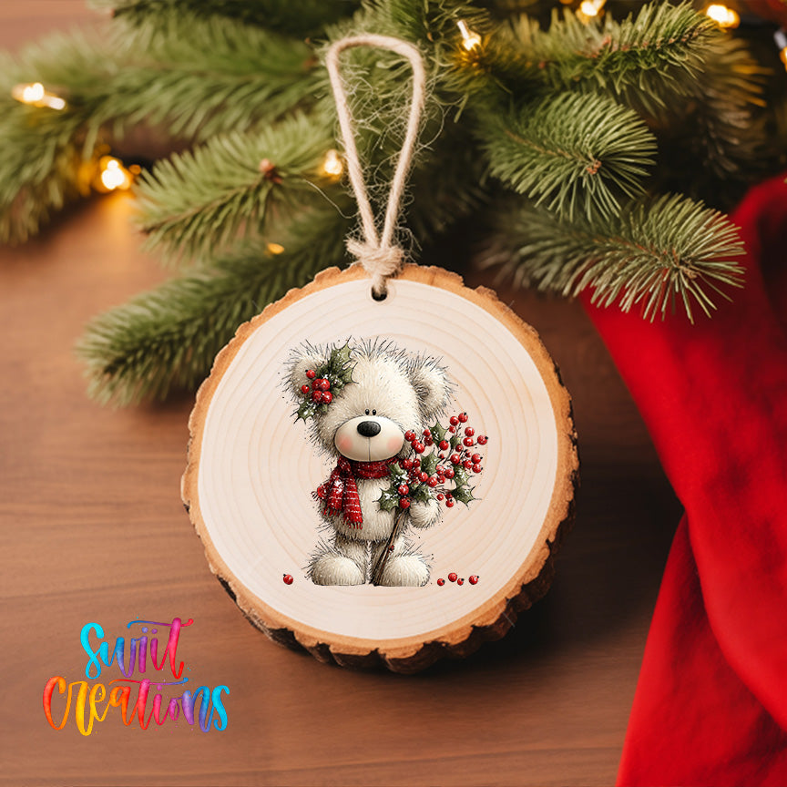 A wooden ornament featuring a teddy bear holding berries, hanging on a Christmas tree.