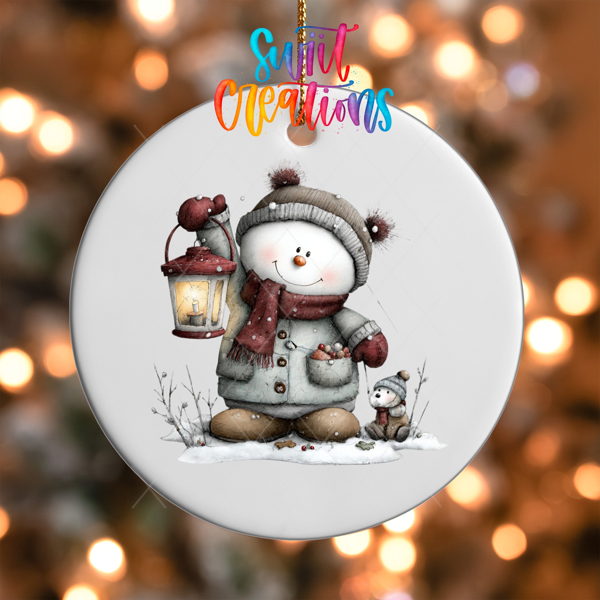 A snowman ornament with a lantern and a smaller snowman companion, set against a blurred background of twinkling lights.