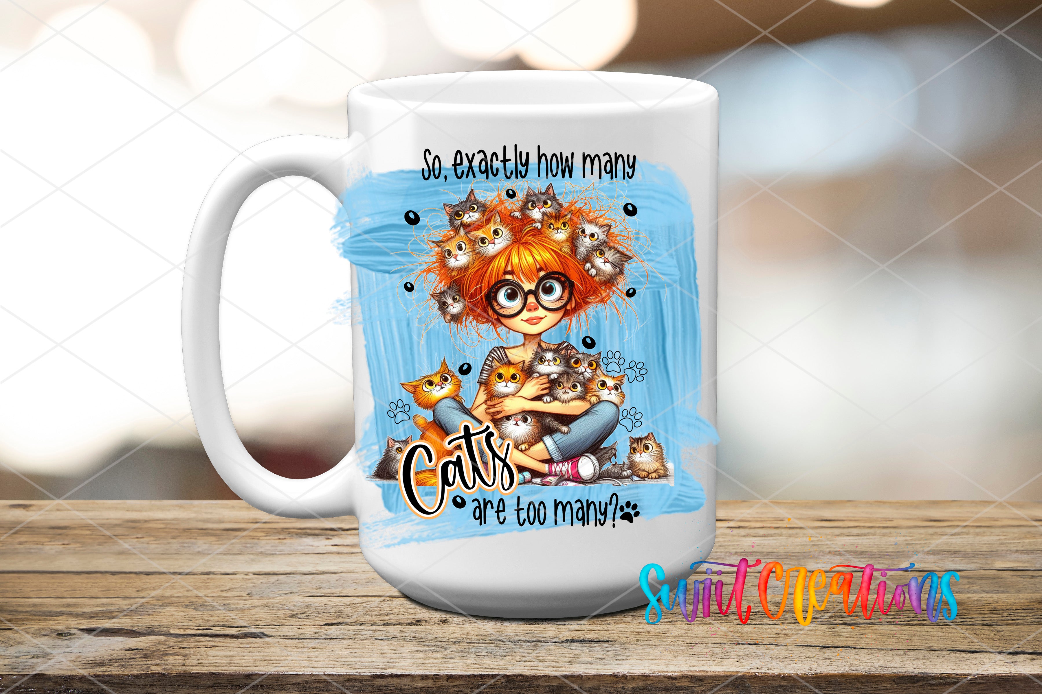 A white ceramic mug with a colorful illustration of a young girl surrounded by cats, along with the text "So exactly how many cats are too many?".