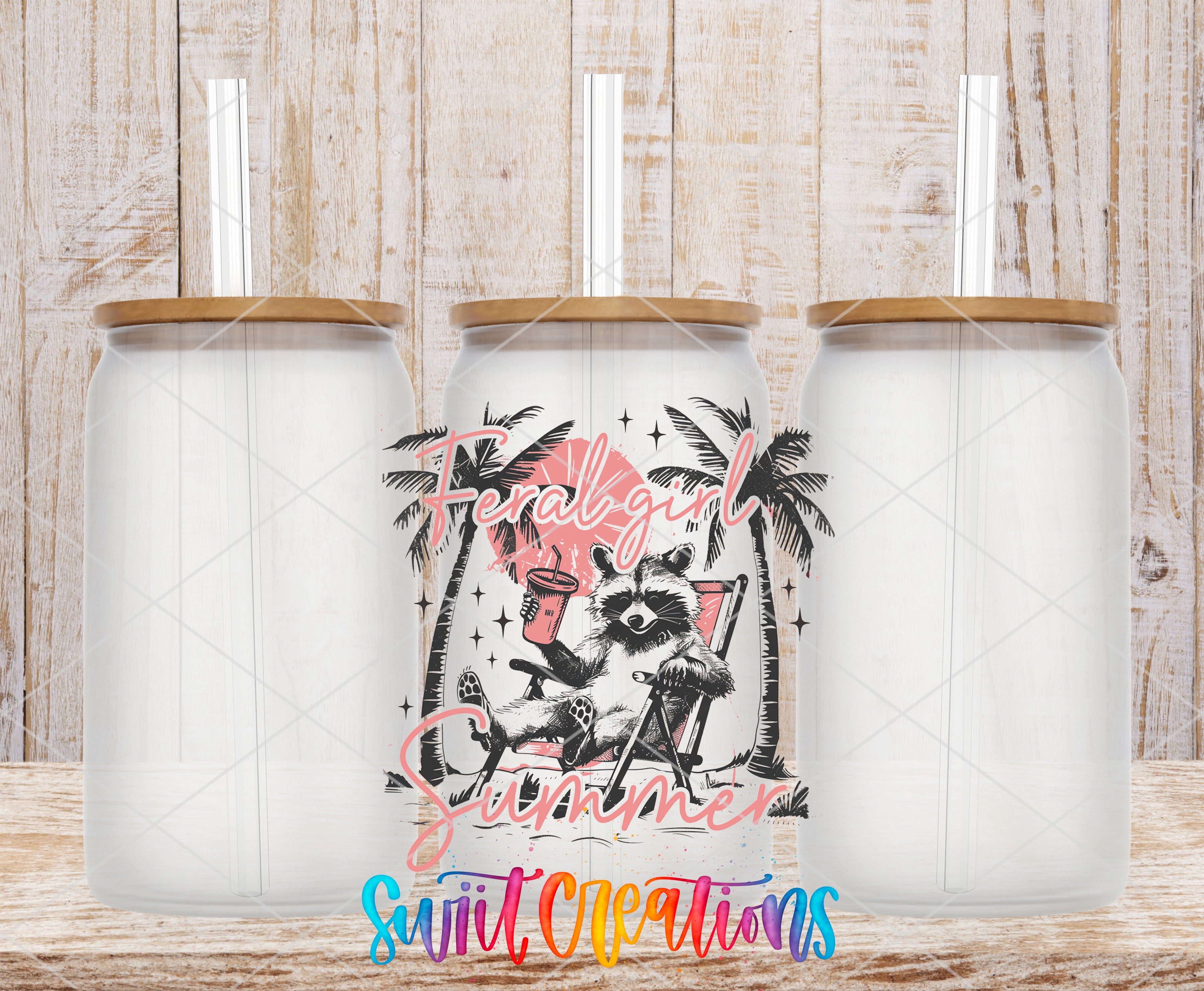 three clear glass tumblers with straws, each with a lid and straw, set against a wooden background. The tumblers have a colorful design depicting a raccoon sitting in a chair and holding a drink.