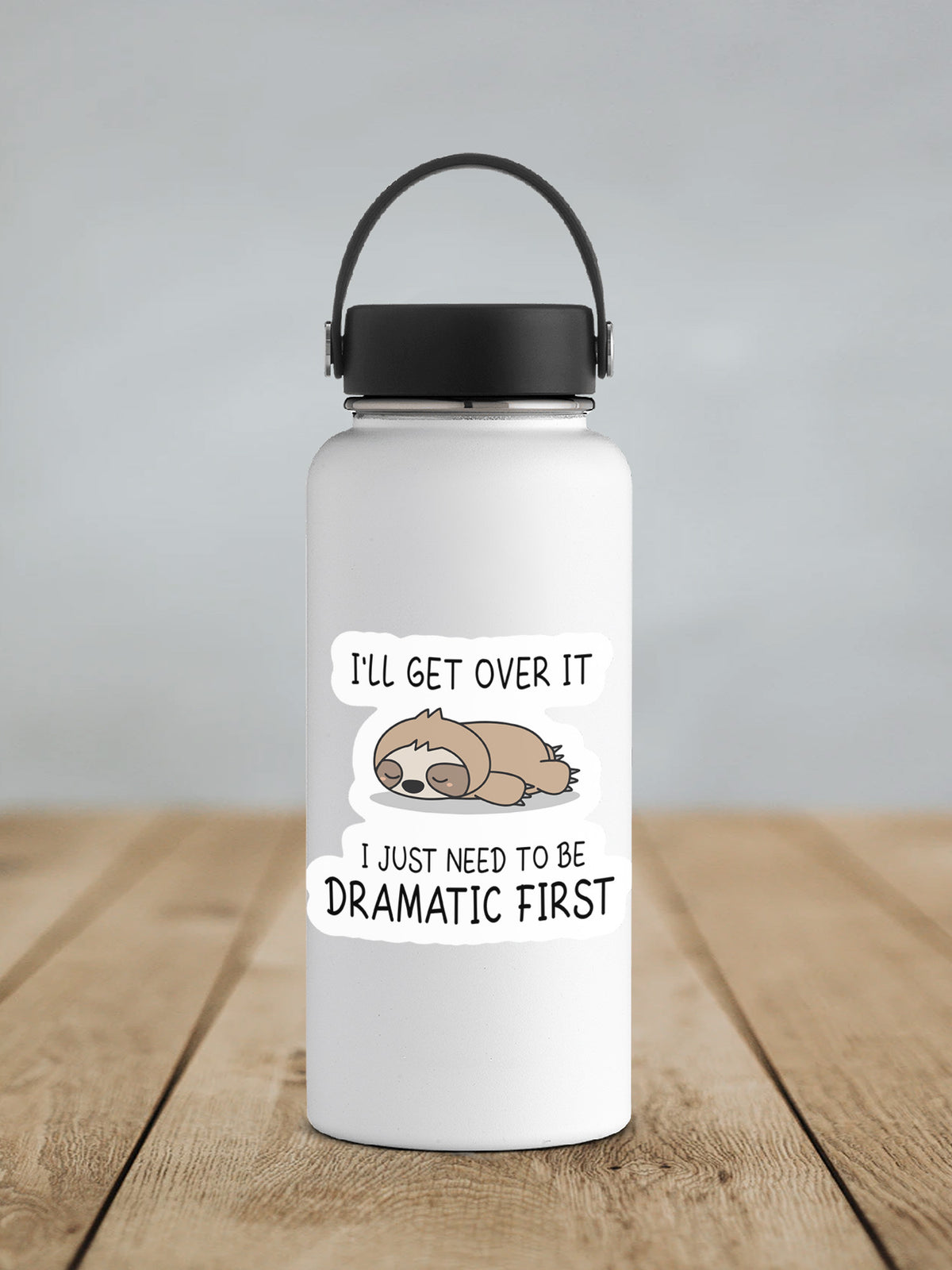 a white water bottle with a black lid on a wooden table