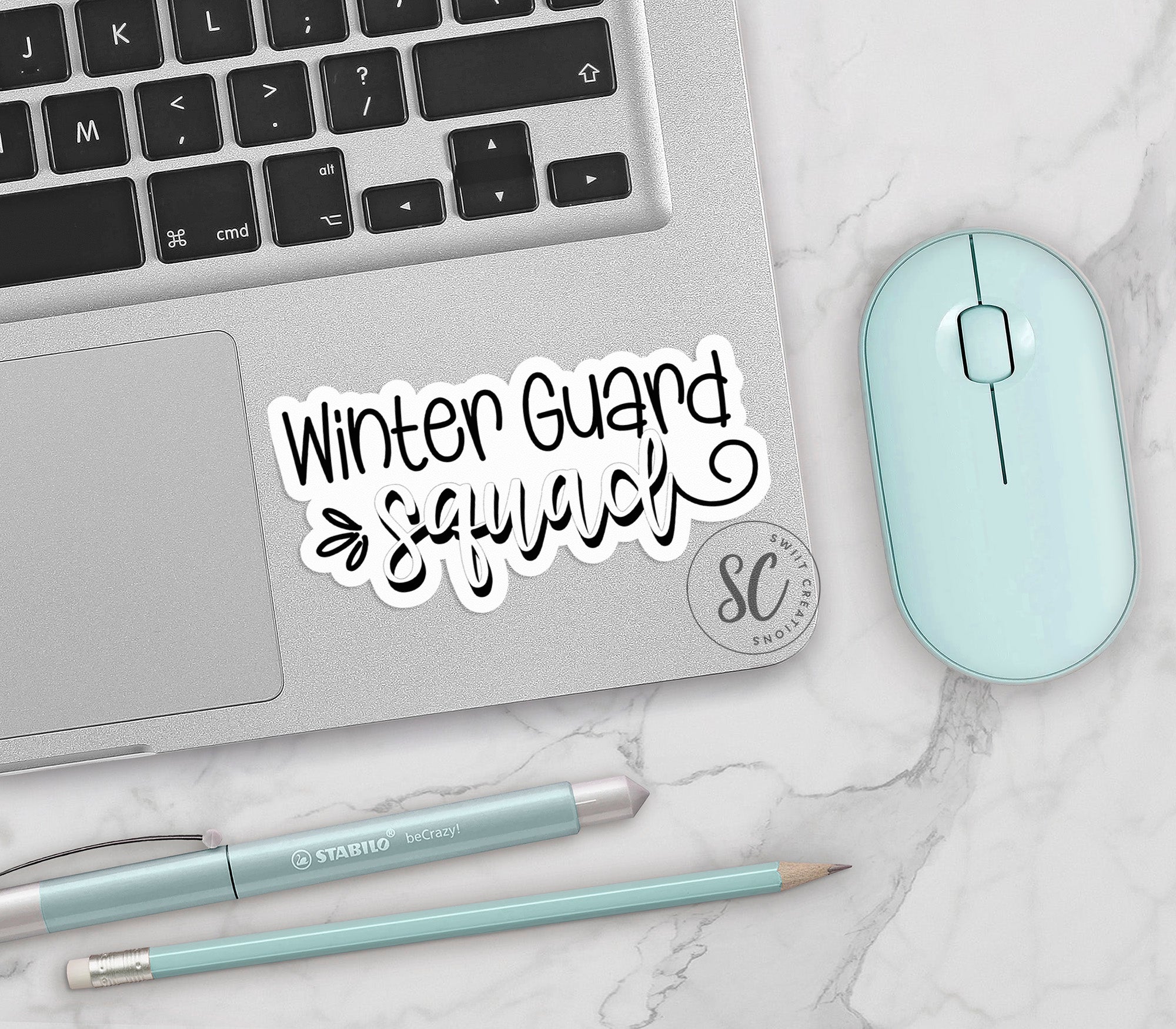 a laptop computer sitting on top of a white table