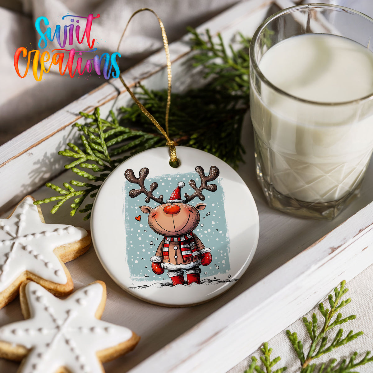 a festive scene with a Christmas ornament, a glass of milk, cookies, and greenery.