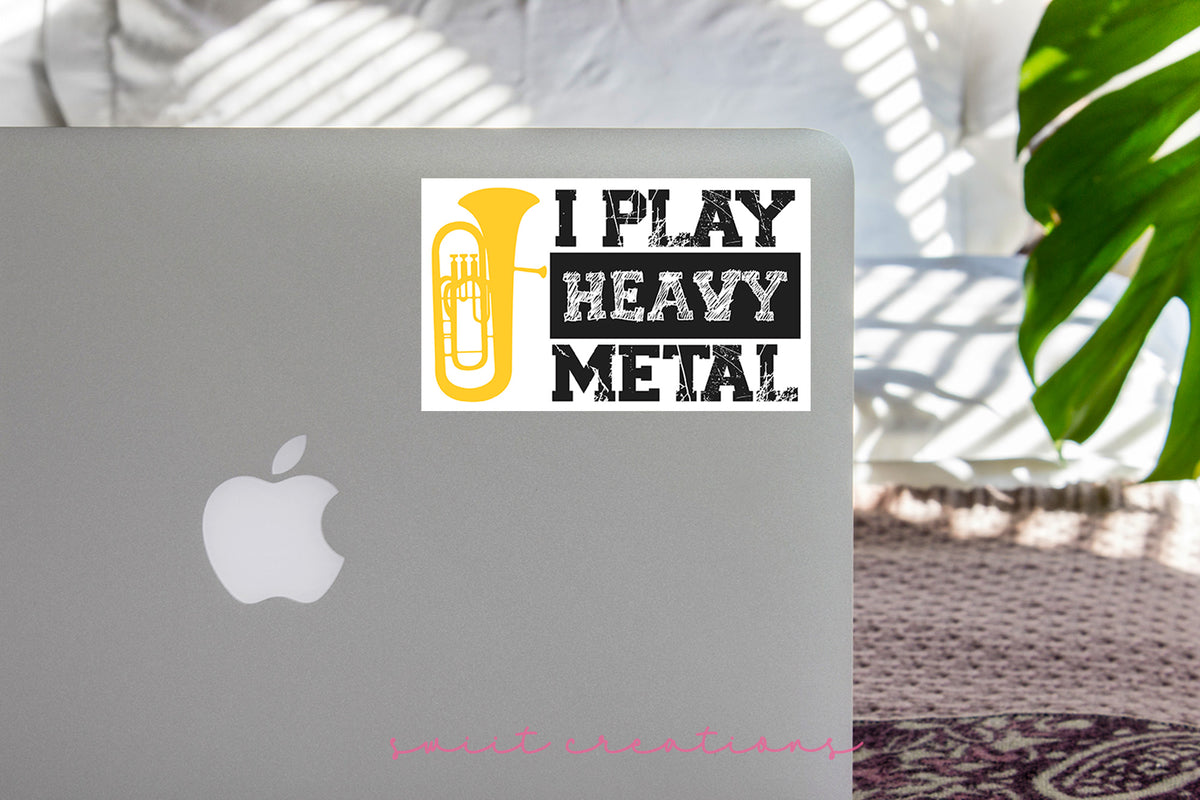a laptop with a sticker that says i play heavy metal