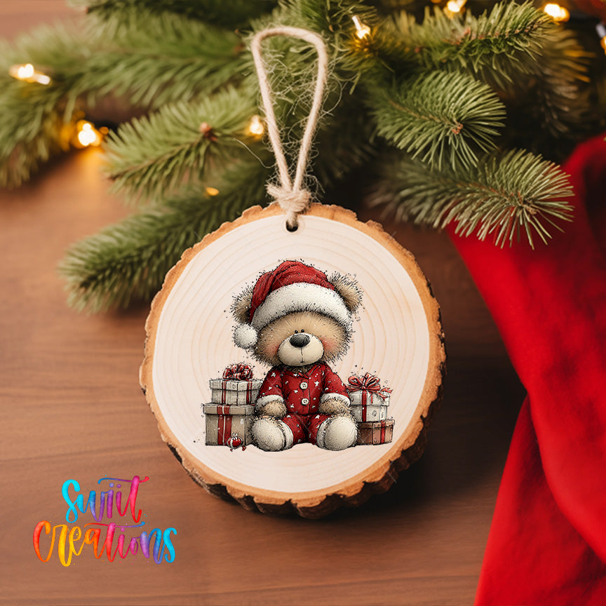 A wooden ornament featuring a teddy bear wearing a Santa hat and holding presents, hanging on a Christmas tree.