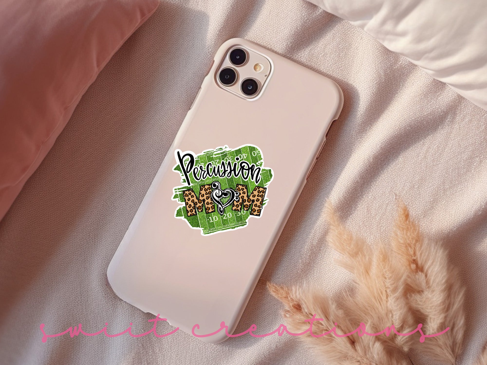 a phone case with a sticker on it sitting on a bed