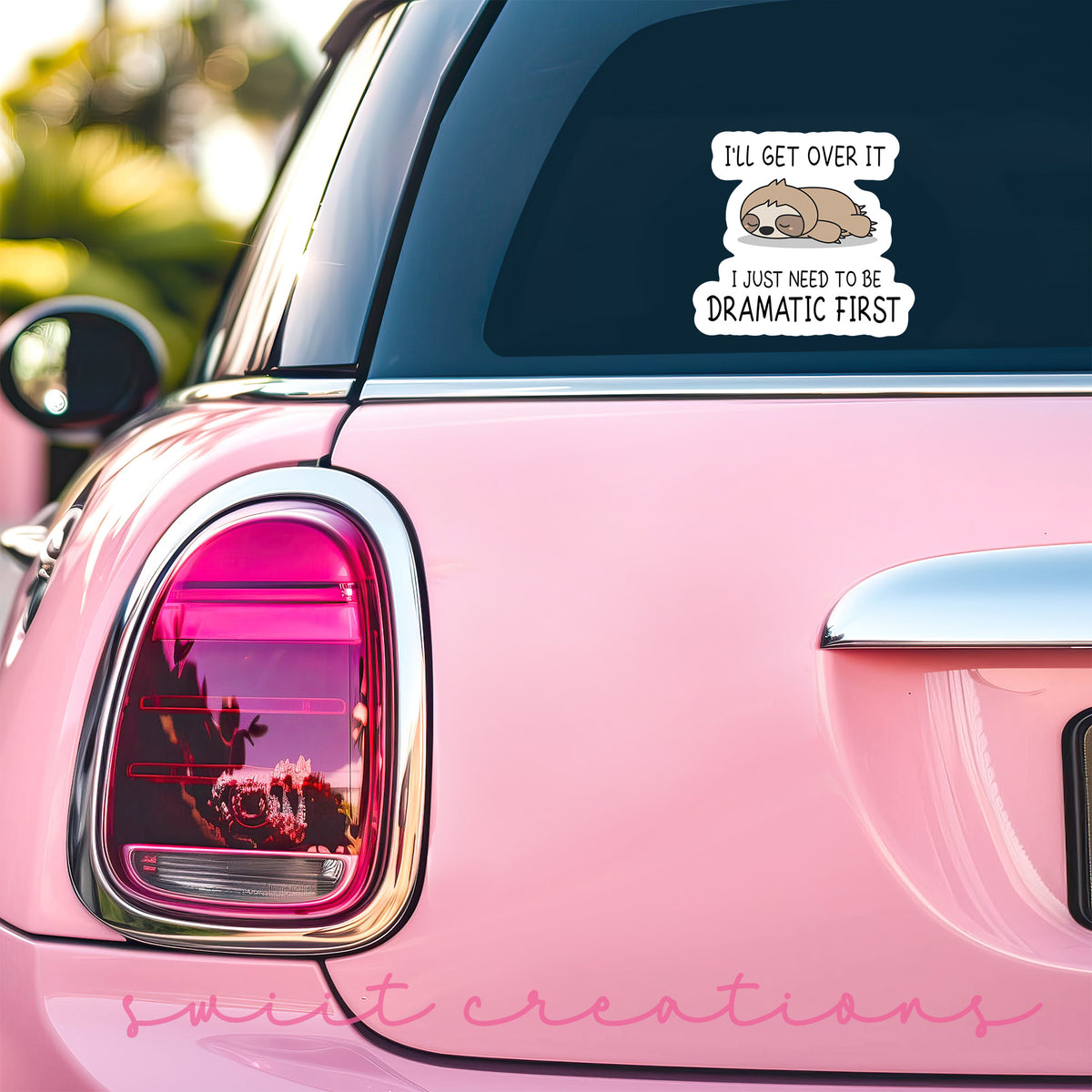 a pink car with a sticker on the back of it