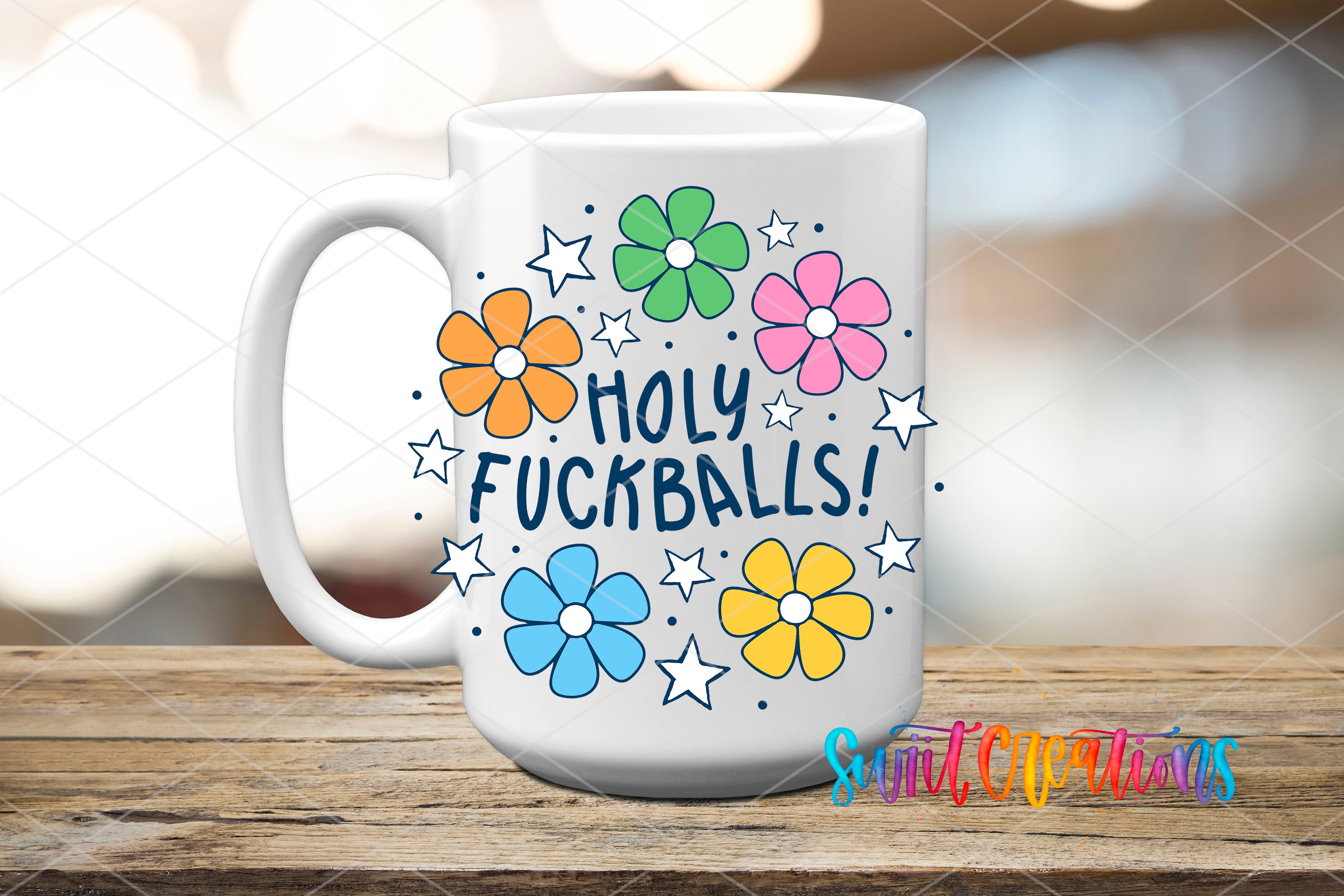 A white mug with a colorful design featuring flowers and stars, along with the text "HOLY FUCKBALLS!"